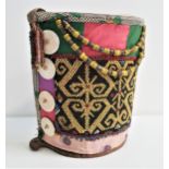 DAYAK BORNEO BABY CARRIER with a woven semi circular body covered in fabric with bead decoration and
