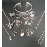 SELECTION OF SILVER JEWELLERY including four rings, pendants on chains, a black enamel set bangle,