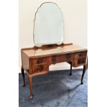 MAHOGANY KNEEHOLE DRESSING TABLE with a shaped mirror back above an arrangement of five drawers,