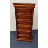 NARROW CHERRY CHEST OF DRAWERS with a moulded top above a cushion frieze drawer and six panelled