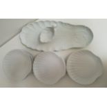 PORCELAIN FISH PLATES in white and comprising a fish serving plate, shell shaped sauce boat and