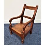 CHILD'S OAK OPEN ARMCHAIR with a solid seat and turned front supports
