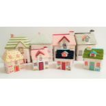 SELECTION OF EIGHT CERAMIC BISCUIT JARS all in the form of cottages, with six designed by Kirstie