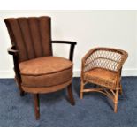 1950S ARMCHAIR with a padded ribbed back above a circular padded seat, standing on turned