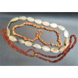 TWO AMBER BEAD NECKLACES one natural amber and the other a double strand polished amber necklace,