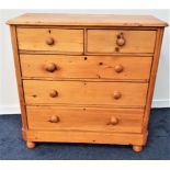 STRIPED AND WAXED PINE CHEST with a moulded top above two short and three long drawers, standing