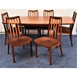 G PLAN TEAK DINING SUITE comprising a table with a pull apart top top and fold out leaf, standing on