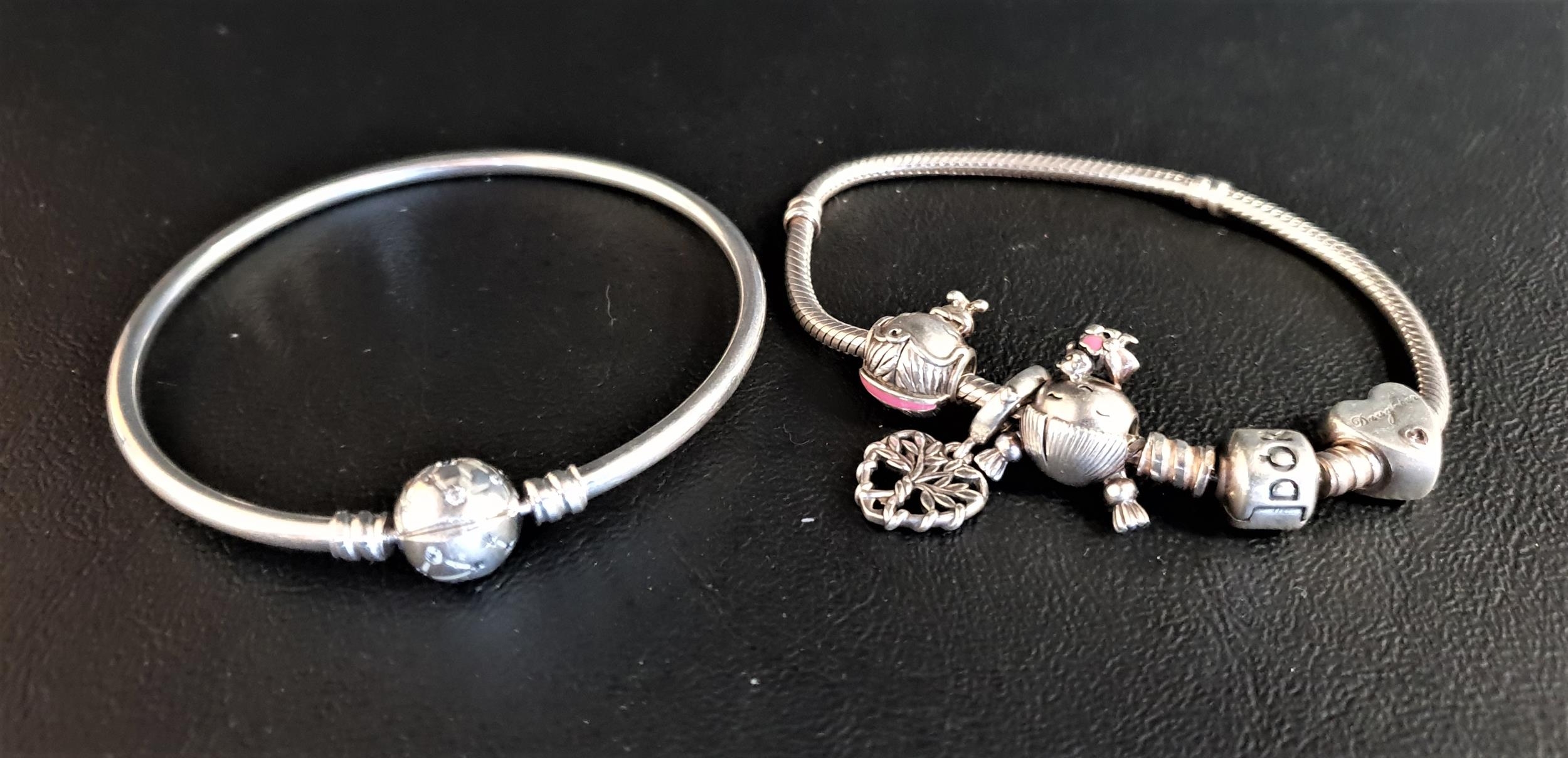 PANDORA MOMENTS SILVER CHARM BRACELET with four charms including a heart and a girl with pigtails;