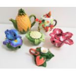 SIX NOVELTY TEAPOTS comprising a pineapple, a cabbage, a red cabbage, strawberries, an Iris and