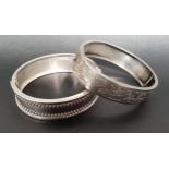 TWO VICTORIAN SILVER HINGED BANGLES one with floral engraved decoration, Birmingham hallmarks for