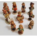 TEN GOEBEL PORCELAIN FIGURINES depicting a boy with an accordion, 8cm high, girl holding a doll, 8.