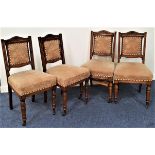 SET OF FOUR EDWARDIAN OAK DINING CHAIRS with shaped carved top rails above padded backs with