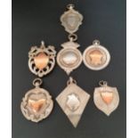 SEVEN SILVER MEDAL FOBS four with gold detail, five with various hallmarks with dates ranging from