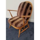 ERCOL BEECH ARMCHAIR with an arched spindle back above shaped arms, with a loose back and seat