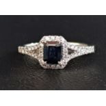 SAPPHIRE AND DIAMOND CLUSTER RING the central emerald cut sapphire approximately 0.4cts in diamond