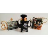 THREE NOVELY CARDEW TEAPOTS comprising a range cooker, a 'Garden Antiques' stall, and
