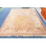 LARGE CHINESE STYLE WASH RUG with a pale brown and mauve ground with floral motifs, fringed, 368cm x