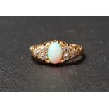 EDWARDIAN OPAL AND DIAMOND RING the central oval cabochon opal flanked by three diamonds to each