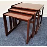 G PLAN QUADRILLE NEST OF TEAK TABLES with square tops standing on shaped supports, 49cm high