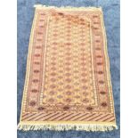 BAKHARA RUG with a green ground decorated with geometric motifs, fringed, 165cm x 99cm