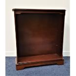 MAHOGANY BOOKCASE THE moulded top with canted corners above adjustable shelves, standing on
