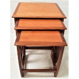 G PLAN QUADRILLE NEST OF TABLES in teak, standing on shaped supports, 51.5cm high