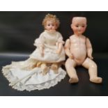 GERMAN BISQUE HEADED DOLL the head marked 320-8 Jep, with blue fixed eyes and open mouth with teeth,