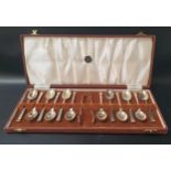 ELIZABETH II TWELVE SILVER TEA SPOONS with an engraved P to the terminals and a pair of sugar tongs,