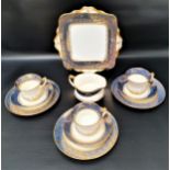 PARAGON TEA SERVICE with a white ground and light blue border with gilt flowers, comprising cups and