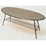 1950s OCCASIONAL TABLE with an oval melamine top standing on metal supports united by a slatted