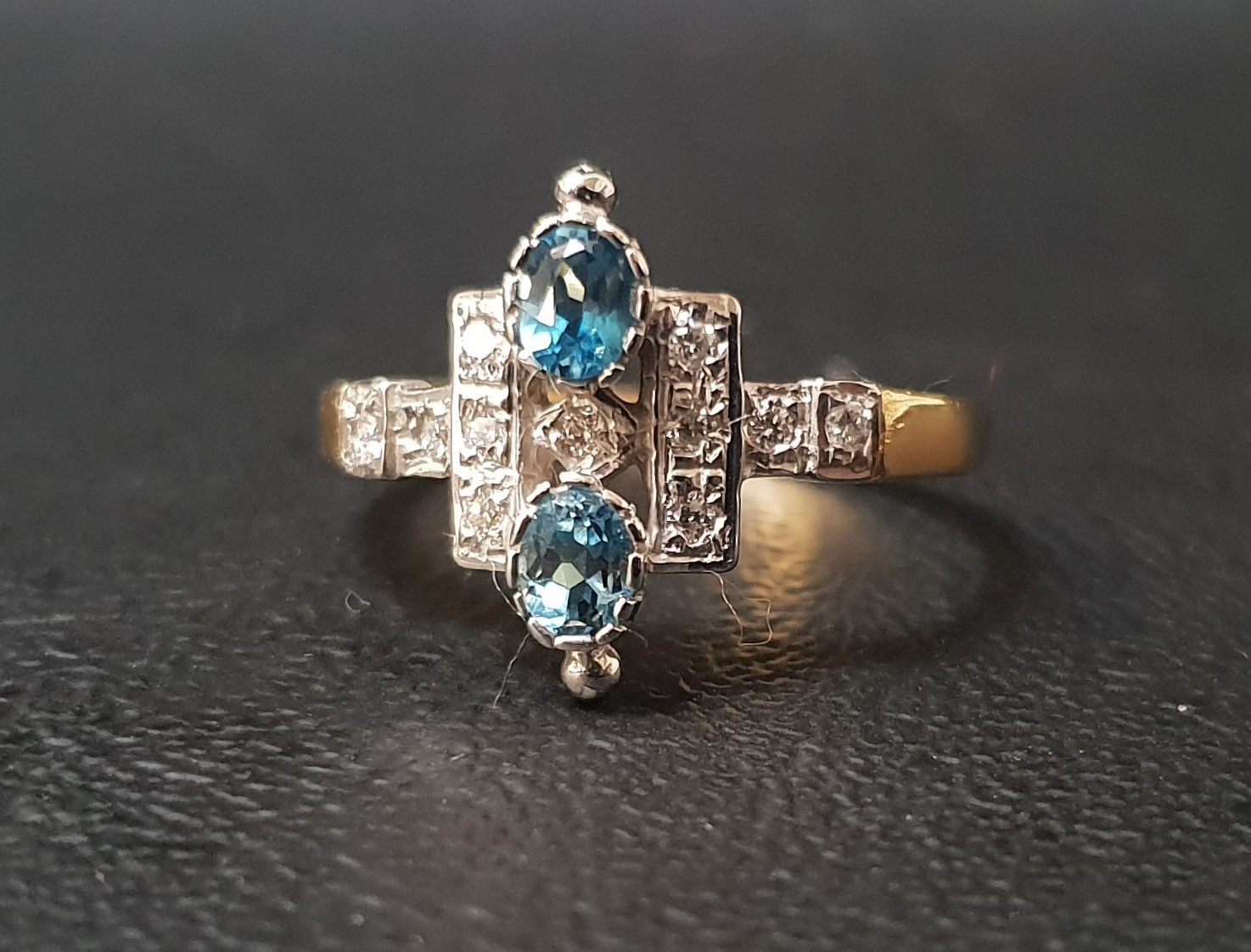 UNUSUAL BLUE TOPAZ AND DIAMOND CLUSTER RING the two oval cut topaz gemstones totalling approximately