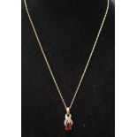 GARNET AND DIAMOND PENDANT the pear cut garnet approximately 0.5cts below diamond set X shaped