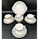 ROSLYN TEA SERVICE with a white ground and light blue and gilt highlights, comprising cups and