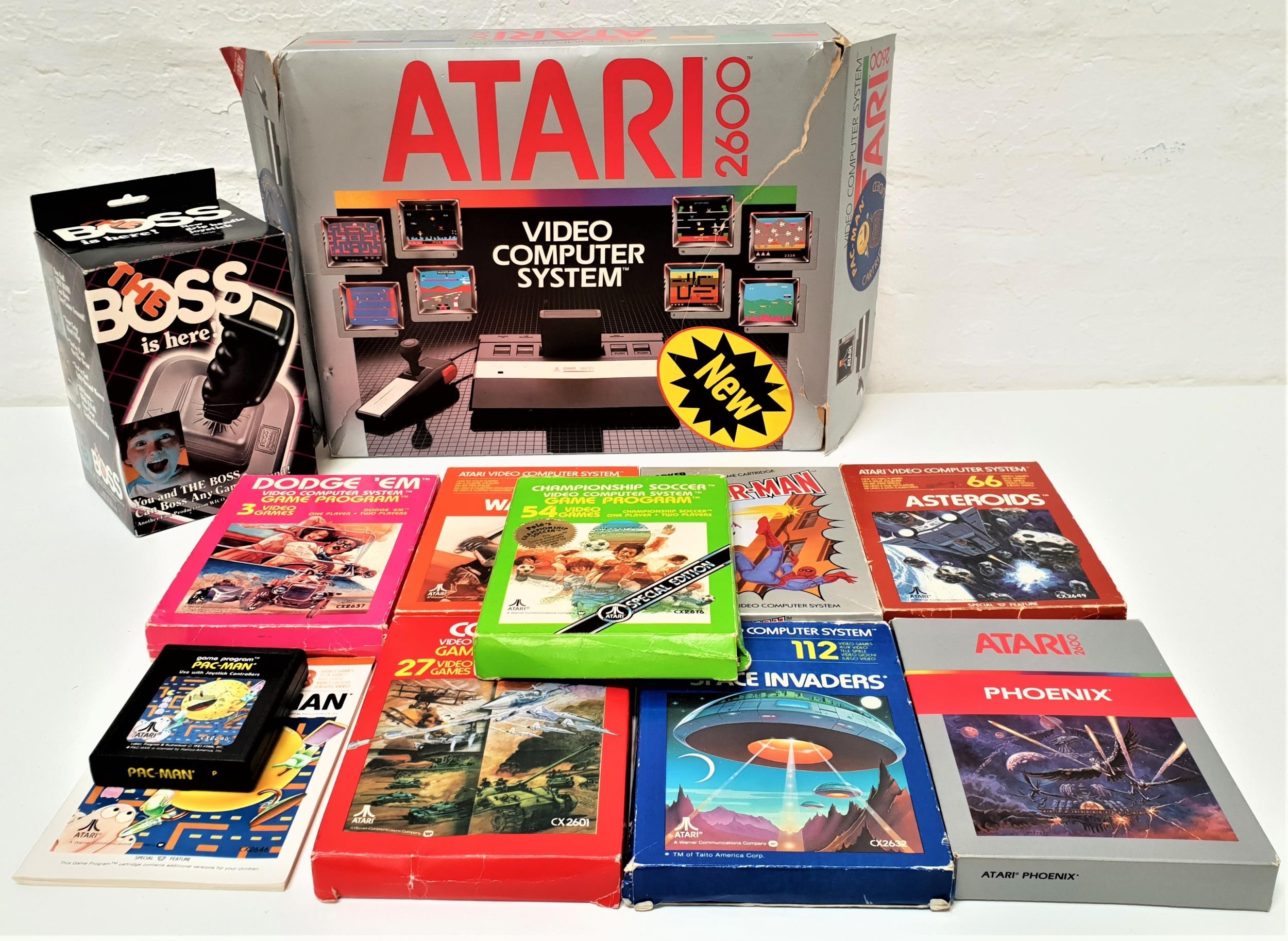 ATARI 2600 VIDEO COMPUTER SYSTEM boxed with cables; together with nine games, all with instruction