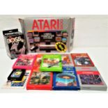 ATARI 2600 VIDEO COMPUTER SYSTEM boxed with cables; together with nine games, all with instruction