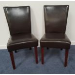 PAIR OF BROWN LEATHER DINING CHAIRS with high padded backs and seats, standing on tapering