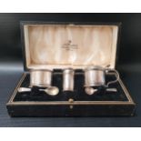 GEORGE V SILVER CRUET SET comprising a pepper pot, salt with blue glass liner, lidded mustard pot