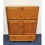 ERCOL LIGHT ELM SIDE CABINET with a fall flap above a pair of cupboard doors with a drawer below, on
