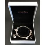 PANDORA MOMENTS SILVER CHARM BRACELET with four charms and a safety chain, with box