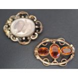 TWO VICTORIAN BROOCHES one with central glazed panel containing coiled hair, the other with