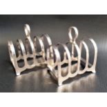 PAIR OF GEORGE VI SILVER TOAST RACKS each with four divisions and a central pierced handle, in a