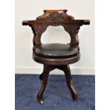 VICTORIAN OAK CAPTAINS SWIVEL CHAIR with a shaped carved top rail and arms above a stuffover