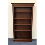 MAHOGANY BOOKCASE with a moulded top above four adjustable shelves, standing on a plinth base, 183cm