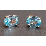 PAIR OF BLUE TOPAZ STUD EARRINGS in nine carat gold, the oval cut topaz on each approximately 1.1cts