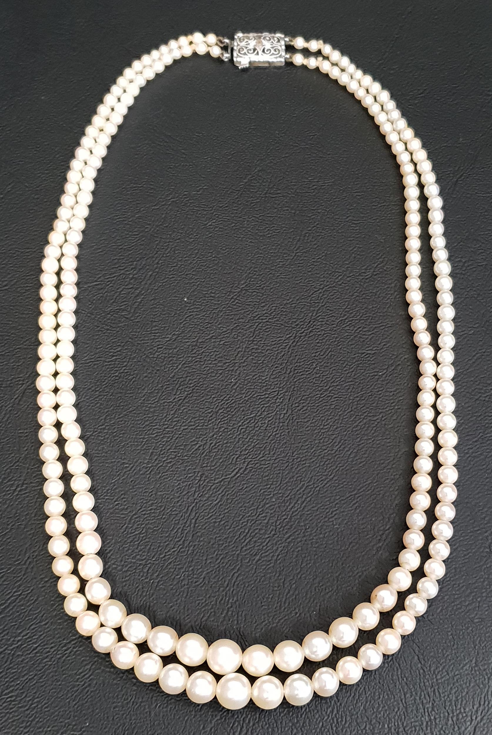 GRADUATED DOUBLE STRAND PEARL NECKLACE with diamond set nine carat white gold clasp, approximately