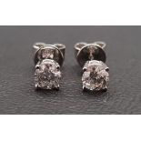 PAIR OF DIAMOND STUD EARRINGS in fourteen carat white gold, the round brilliant cut diamonds on each