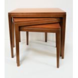 NEST OF TEAK TABLES with rectangular tops, standing on tapering supports, 46cm high