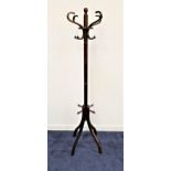 STAINED ASH BENTWOOD COAT STAND raised on four shaped supports with a turned column and shaped