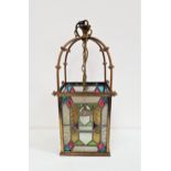 GLASS AND BRASS HALL LANTERN with a suspension chain and four shaped arms above a four sided shade