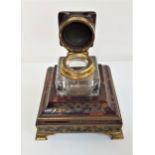 LATE 19th CENTURY TORTOISESHELL AND BRASS BOULLE INK STAND with a heavy cut glass inkwell having a